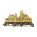 Chinese landscape soapstone carving raised on a naturalistic base, 28cm wide :For Further