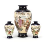 Three Japanese Satsuma pottery vases including a pair, each hand painted with flowers, the largest