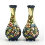 Pair of Moorcroft pottery vases, hand painted with stylised flowers and foliage, each 17cm high :For