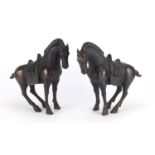 Pair of Chinese patinated bronze Tang style horses, each 29.5cm high :For Further Condition