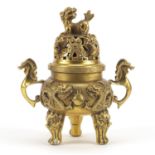Chinese gilt tripod censer and cover with twin handles, decorated in relief with dragons chasing the