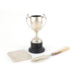 Silver items including a rectangular cigarette case and a twin handled trophy on stand, various