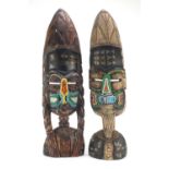 Two tribal interest carved face masks with beadwork, the largest 63cm high :For Further Condition