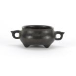 Chinese bronze tripod censer with twin handles, impressed character marks to the base, 11cm wide :
