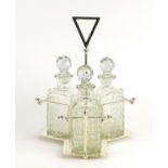 Modernist silver plated three bottle tantalus in the style of Christopher Dresser, housing three cut