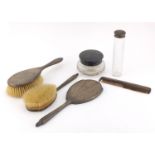 Silver mounted vanity items including a pair of brushes, hand mirror and cut glass powder pot,