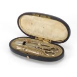 19th century French ebonised necessaire housing silver gilt implements including scissors, needle