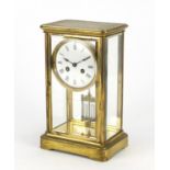 French brass cased four glass mantel clock striking on a bell, the enamelled dial with Roman