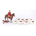 Beswick huntsman on horseback with eight hounds and a fox, the largest 21cm high :For Further