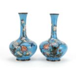 Pair of Japanese cloisonné vases, each enamelled with birds amongst blossoming trees, each 18.5cm