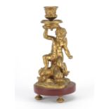 Classical gilt painted cherub and dolphin design candlestick, raised on a circular marble base, 22.