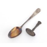 Antique unmarked silver caddy spoon and a sterling silver tablespoon, the largest 17cm in length,