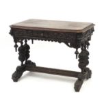 19th century Flemish oak centre table carved with lion heads and dolphin feet, 75cm H x 100cm W x
