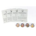 Four United States of America coloured silver dollars, with certificates comprising dates two 2001