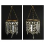 Pair of brass bag chandeliers with cut glass lustre drops, each 35cm high x 13cm in diameter :For