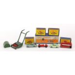 Four Matchbox Series die cast vehicles and a Dinky Super Toys lawnmower, all with boxes, the