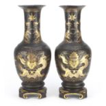 Pair of Chinese papier-mâché vases on stands, both gilded with dragons chasing the flaming pearl,