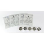 Five United States of America silver dollars with certificates including Korean War, World War II