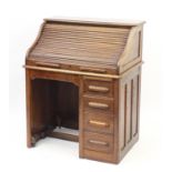 Oak tambour front roll top desk with four drawers to the base, 114cm H x 90cm W x 66cm D :For