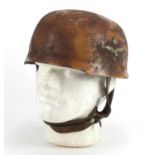 German Military interest tin helmet with decals and leather liner, impressed marks to the