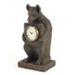 Black forest style carved wood bear design clock, with enamelled dial and Roman numerals, 30.5cm