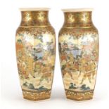 Pair of Japanese Satsuma pottery vases with hexagonal bodies, each hand painted with warriors and