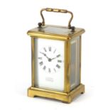 Brass cased carriage clock with enamelled dial and Roman numerals, retailed by Dickinson Silver