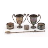 Silver items including a pair of miniature twin handled trophies, pair of napkin rings and an