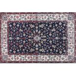 Rectangular persian rug having an all over floral design onto a blue and cream ground, 140cm x