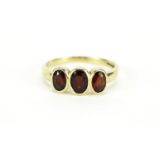 9ct gold garnet three stone ring, size S, 2.9g :For Further Condition Reports Please Visit Our