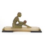 Art Deco bronzed sculpture of a female holding a ball, raised on an onyx and black slate base,