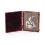 Georgian hand painted portrait miniature of a female reading, mounted and housed in a red leather