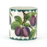 Wemyss Ware cylindrical pot, hand painted with plums, retailed by T Goode & Co, factory marks to the