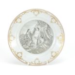 Chinese porcelain en grisaille plate, hand painted with a European scene within a gilt border,