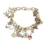 Silver charm bracelet with a selection of mostly silver charms including a rickshaw, penny