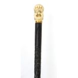Ebony walking stick with carved bone pommel in the form of a judge's head, 90cm in length :For