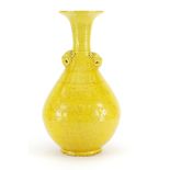Chinese yellow glazed porcelain vase with mythical head handles, incised with a dragon and phoenix