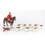 Beswick huntsman on horseback with eight hounds and a fox, the largest 21cm high :For Further