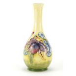 Moorcroft pottery vase hand painted in the Yellow Orchid pattern, impressed marks and paper label to