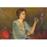 Female with flowers in an interior, oil on board, bearing a signature Laura Knight, mounted and