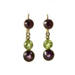 Pair of unmarked gold Suffragette earrings set with garnets, peridot and seed pearls, 2.5cm in