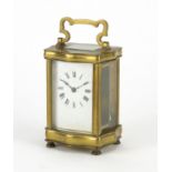 French brass cased serpentine fronted carriage clock with enamelled dial and Roman numerals, 12cm