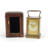 Large French brass cased carriage clock with enamelled chapter ring, Arabic numerals and leather