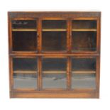 1920's oak sectional bookcase by Gumm with four doors and two sliding panels, 125cm H x 128cm W x