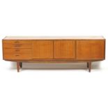Vintage teak sideboard fitted with a fall, pair of cupboard doors and three drawers, possibly