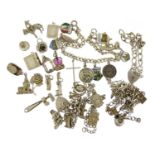 Silver charm bracelets with a large selection of mostly silver charms, including enamelled