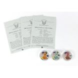 Three 2005 United States of America coloured silver dollars, with certificates :For Further