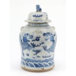 Large Chinese blue and white porcelain jar and cover, hand painted with dragons chasing the