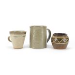 Studio pottery comprising a John Leach Studio Pottery Bovey Tracy mug, Leach pottery mug and a