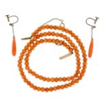 Coral bead necklace and a pair of earrings with silver mounts, the necklace 40cm in length :For